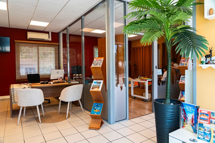 L'espace de réception de l'agence et son présentoir de brochures de voyage